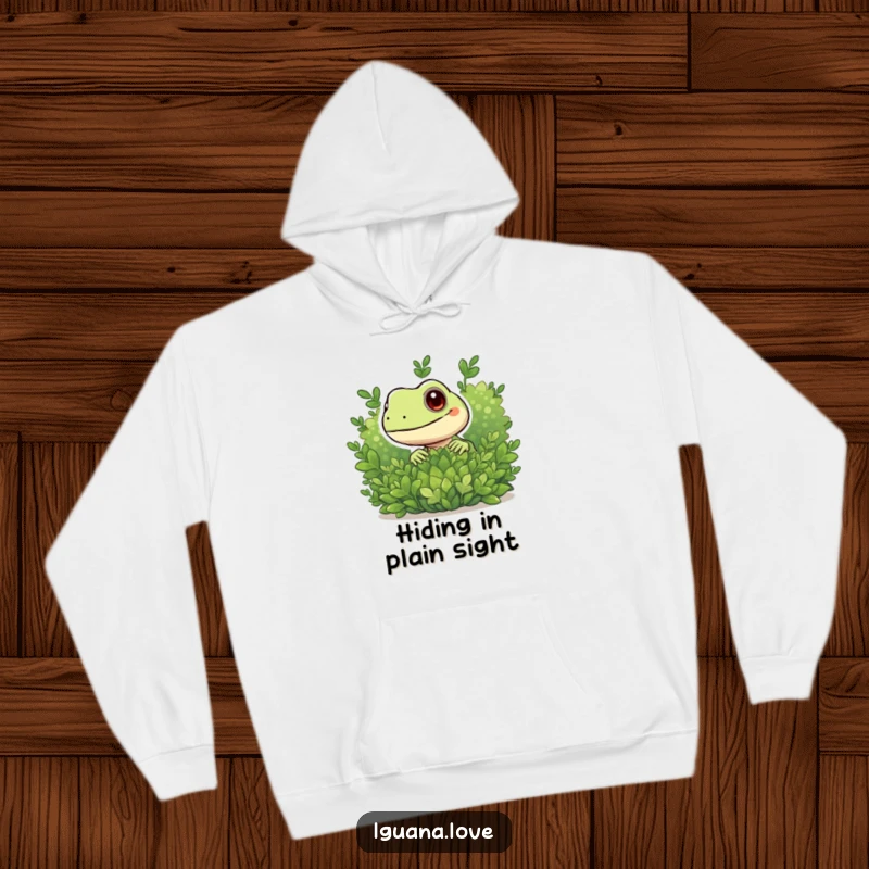 Funny hoodie featuring a playful iguana character peeking from behind foliage, adding a touch of mystery and fun.